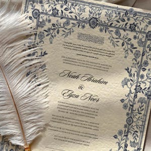 May include: A cream-colored wedding certificate with blue floral borders. The text reads "This agreement, made on the 27th day of August, 2019, corresponding to the 15th day of Safar, 1441 AH, in Mississauga, ON, is to formally the marriage of Noah Ibrahim & Elyza Noor."