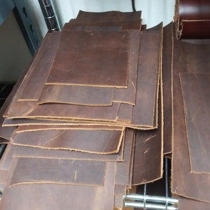 May include: A stack of brown leather sheets, likely for crafting projects.