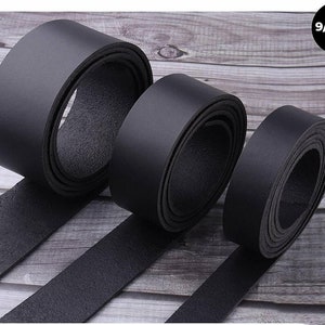 May include: Three black leather straps of different widths, laid out on a wooden surface. The straps are rolled up and the text "9/10 oz." is visible in the top right corner of the image.