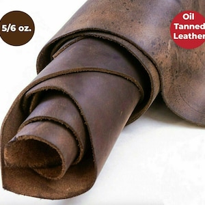 May include: A roll of brown oil tanned leather, 5/6 oz. in thickness. The leather has a distressed, rustic look.