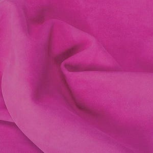 May include: A vibrant magenta fabric with a soft, matte texture and deep folds. A red tag hangs from the top left corner, featuring the black text TWO FOR ONE SALE, indicating a promotional offer for this piece of material.