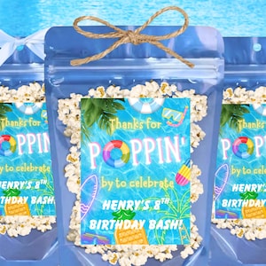May include: Three clear cellophane bags filled with popcorn, tied with twine bows. Each bag has a label with the text "Thanks for POPPIN' by to celebrate HENRY'S 8TH BIRTHDAY BASH!" with pool-themed graphics.
