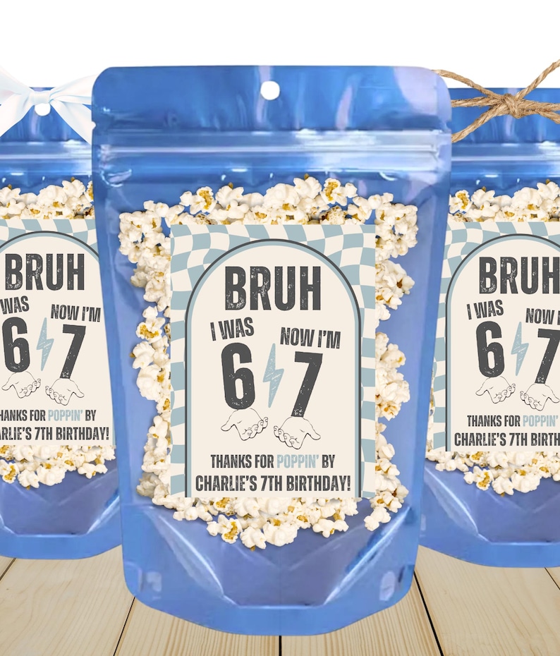 May include: Three blue cellophane bags filled with popcorn. Each bag has a label that reads "BRUH I WAS 6 NOW I'M 7" with the text "THANKS FOR POPPIN' BY CHARLIE'S 7TH BIRTHDAY!" The bags are tied with a white ribbon and twine.