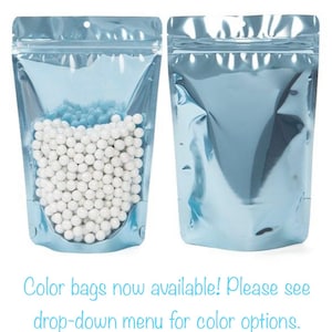May include: Two light blue stand-up pouches with zipper closures. One pouch is filled with white round beads. The text on the image reads: "Color bags now available! Please see drop-down menu for colour options."