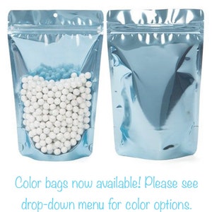 May include: Two light blue stand-up pouches with a zipper closure. One pouch is filled with white round beads. Color bags now available! Please see drop-down menu for color options.