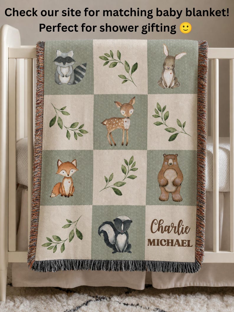 May include: A woven throw blanket featuring a grid pattern of alternating beige and sage green squares. The squares display illustrations of a raccoon, rabbit, deer, fox, bear, skunk, and green leaves. The name Charlie Michael is printed in brown.