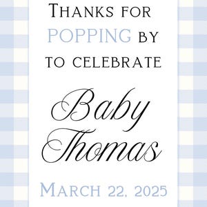May include: A white card with a blue gingham pattern border. The card says "Thanks for popping by to celebrate Baby Thomas March 22, 2025".