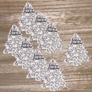 May include: Set of eight Christmas tree-shaped gift tags with a gray and white leopard print design. Each tag has the text "Merry Christmas" and spaces for "To:" and "From:".