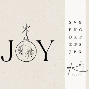 May include: Black and white line art illustration of the word "JOY" with a Christmas ornament in place of the "O". The ornament has a bow and holly leaves. The text "DESIGN STUDIO" is written in cursive below the word "JOY".