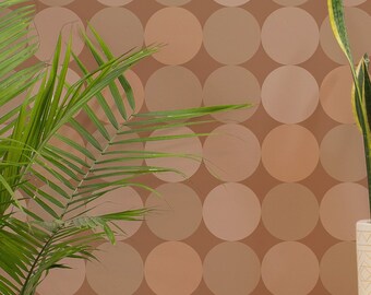 May include: A white chair with a black and white patterned cushion sits in a room with a gold floor lamp and a potted snake plant. The wall is covered in a brown and beige wallpaper with a repeating circle pattern.