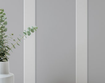 May include: A white ceramic vase with a rounded body and a narrow neck, filled with a sprig of eucalyptus.