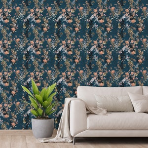 Teal Wildflowers self-adhesive wallpaper with scattered leafy stems and peach blooms on deep teal, living room wall behind sofa.