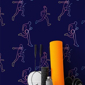 May include: A navy blue wall with a repeating pattern of running figures in a rainbow gradient. Fitness equipment, including a foam roller, dumbbells, and a jump rope, is arranged in front of the wall.