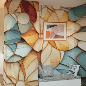 May include: A white bench with a cushion and two storage compartments. The bench is in front of a wall with a colorful abstract floral pattern. The text "There is no place like home" is on a white pillow on the bench.