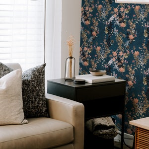 Teal Wildflowers removable wallpaper with scattered flowing stems and blossoms on a deep teal field, living room wall.