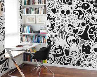 May include: A contemporary home office with a black and white skull-themed wallpaper. The room includes a white desk with a laptop, a black chair, and a built-in bookshelf filled with books. The floor is made of dark wood.
