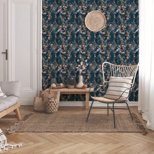 Teal Wildflowers peel and stick wallpaper covers a living room wall with scattered stems and soft blooms on deep teal.