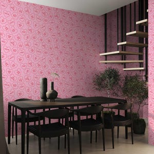 May include: A dining room with a pink wallpaper featuring a repeating pattern of red hearts with the words "Kiss Me" and "Sweet" inside. The room has a black dining table with six black chairs and a potted plant.