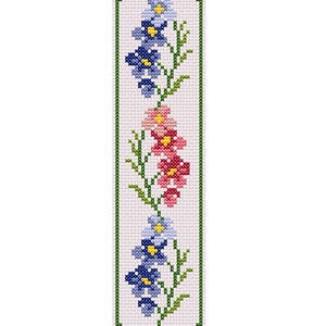 May include: A cross-stitch bookmark with a floral pattern. The bookmark has a white background and a green border. The flowers are blue, pink, and red with yellow centres and green stems. The bookmark is a vertical rectangle.