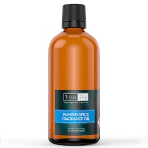 May include: A brown glass bottle with a black cap and a white label. The label says "Fresh Skin" and "Pumpkin Spice Fragrance Oil".