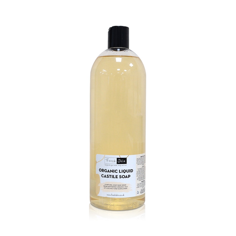 May include: A clear plastic bottle of organic liquid castile soap with a black cap. The bottle is labeled "Fresh Skin Organic Liquid Castile Soap" and includes the text "A natural soap base made with pure plant oils, including oils of coconut and sunflower."