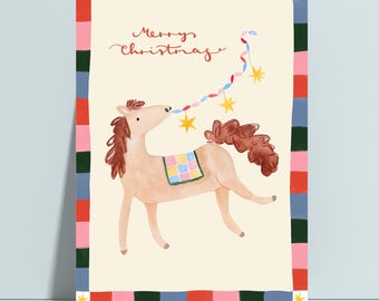 May include: A rectangular greeting card featuring a light brown horse with a brown mane and tail, wearing a colorful checkered blanket. The horse holds a string of colorful lights and yellow stars. The text Merry Christmas is written in red.
