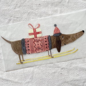 May include: A brown dachshund wearing a red and gray sweater with a white gift on its back is skiing on yellow skis.