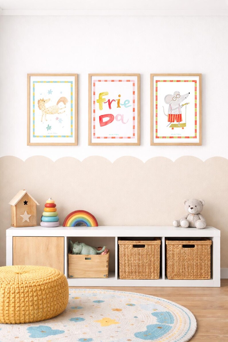 May include: Three framed watercolor prints with animal illustrations and the word "Friend" in colorful letters. A white shelf holds toys, including a wooden house, a rainbow, and a teddy bear. A yellow pouf and a round rug complete the scene.