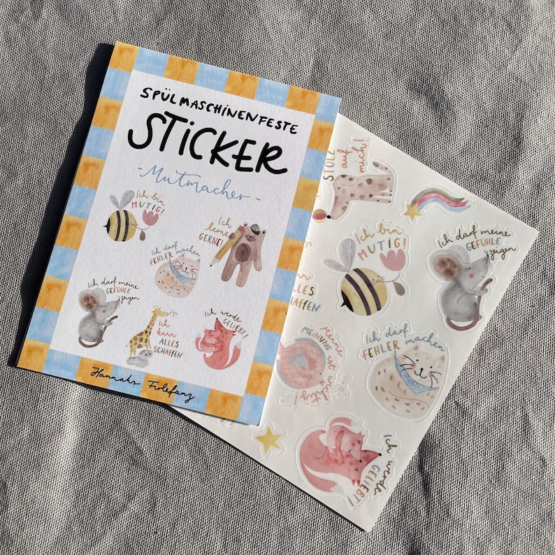 K&ouml;nnte beinhalten: Ein Stickerbogen und ein Heft mit dem Text "SP&Uuml;L MASCHINEN FESTE STICKER - Mutmacher-". Die Aufkleber zeigen Illustrationen einer Biene, Maus, Katze, eines Fuchses und eines B&auml;ren mit deutschen S&auml;tzen.