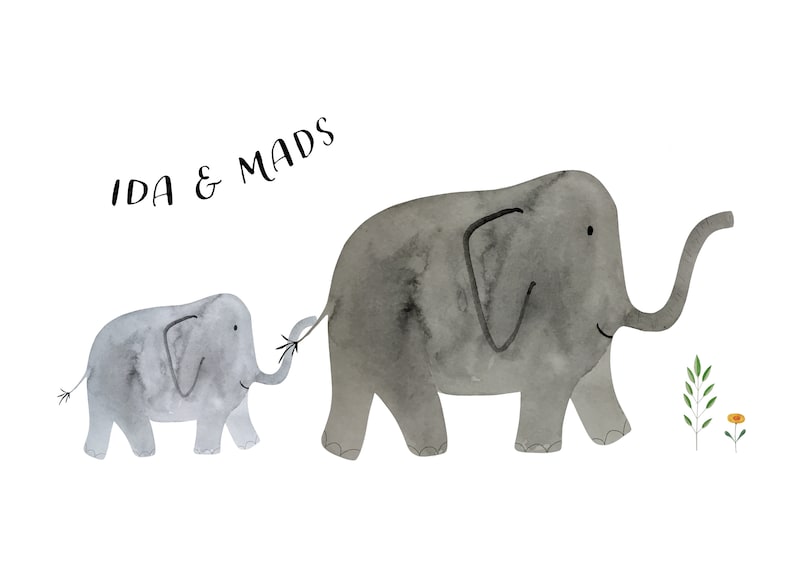 May include: Watercolor illustration of two gray elephants, a larger one and a smaller one, walking together. The smaller elephant holds the tail of the larger one. The text "IDA & MADS" is at the top. Green leaves and a yellow flower are on the right.
