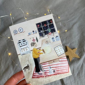 May include: A watercolor illustration of a person rolling out dough in a kitchen with a red and white striped rug, a dog, and a window with a night sky and stars.