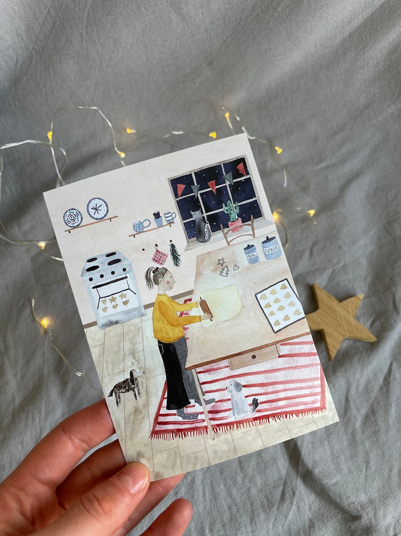 May include: A watercolor illustration of a person rolling out dough in a kitchen with a red and white striped rug, a dog, and a window with a night sky and stars.