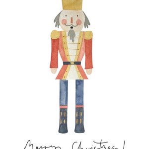 May include: A watercolor illustration of a nutcracker soldier wearing a red and gold uniform, a blue crown, and blue boots. The nutcracker is standing on a white background with the text "Merry Christmas!" written below.