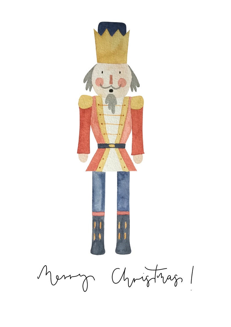 May include: A watercolor illustration of a nutcracker soldier wearing a red and gold uniform, a blue crown, and blue boots. The nutcracker is standing on a white background with the text "Merry Christmas!" written below.