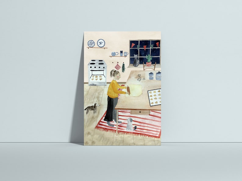 Puede incluir: Una ilustraci&oacute;n de acuarela de una persona extendiendo masa sobre una mesa en una cocina. Hay dos perros en la habitaci&oacute;n, un &aacute;rbol de Navidad y una ventana con vista a una noche estrellada.