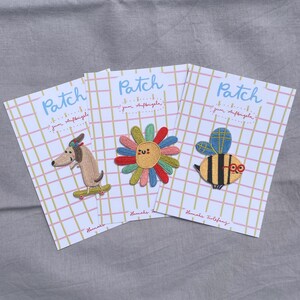 May include: Three embroidered patches on cards. One features a dachshund on a skateboard, another a smiling flower, and the third a bee wearing glasses. Each card has the word "Patch" and the text "zum Aufb&uuml;geln".
