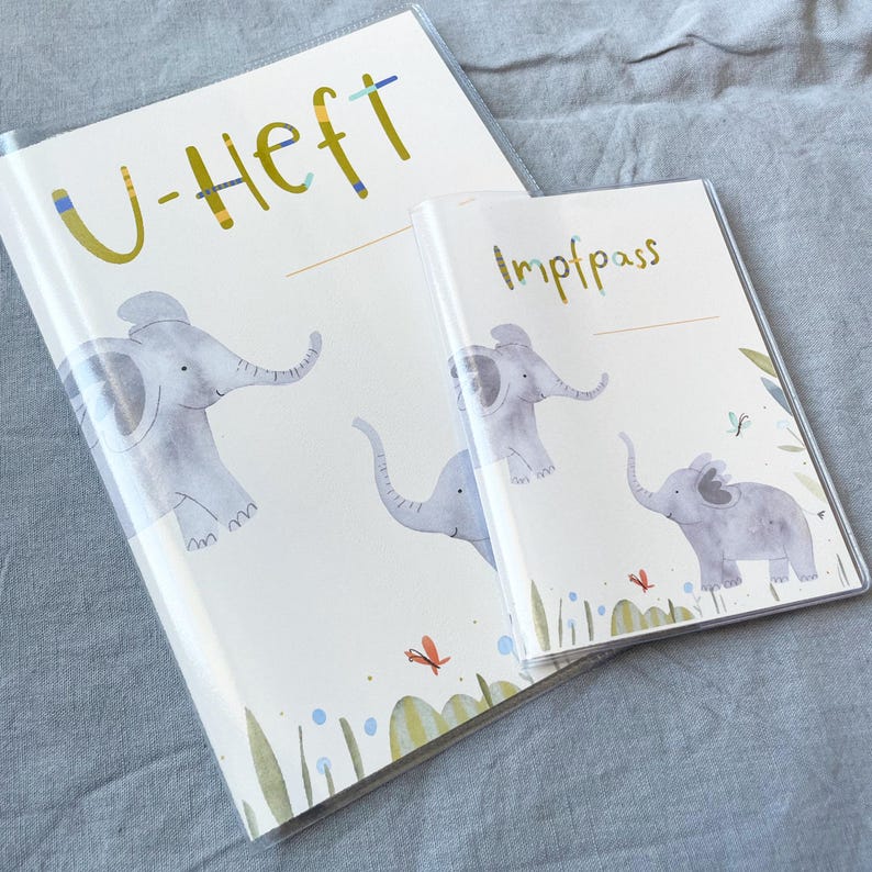 May include: Two colourful folders with elephant illustrations and the text "U-Heft" and "Impfpass".