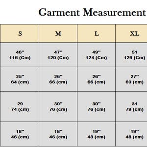 May include: A garment measurement chart with size, chest, sleeve length, length, and shoulder measurements in inches and centimeters. Sizes range from XS to 3XL. The chart is for clothing.