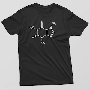 May include: Black t-shirt with a white chemical structure of caffeine printed on the front.