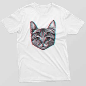 May include: White t-shirt featuring a graphic of a cat's face with four eyes in a 3D style.