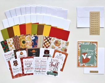 May include: A collection of fall-themed stationery items, including cards, envelopes, and decorative paper. The cards feature autumn-related text and illustrations, such as pumpkins, leaves, and a fox. The color palette includes orange, brown, green, and yellow.