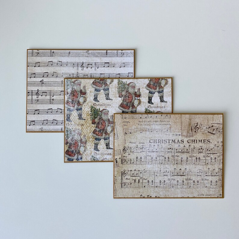 May include: Three vintage-style Christmas cards with a brown border. The top card features a musical score with treble clef and notes. The middle card features a repeating pattern of Santa Claus figures with a Christmas tree and the word "Christmas". The bottom card features a musical score with the words "Christmas Chimes".