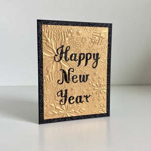 Cartes de bonne année faites à la main en noir et or avec des accents de paillettes