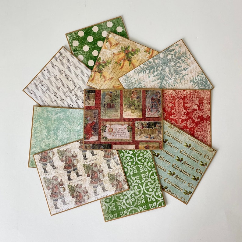 May include: Assortment of patterned paper sheets with a Christmas theme. The papers feature various designs, including musical notes, snowflakes, polka dots, and a Santa Claus illustration. The text "Christmas Merry Christmas" is repeated on several of the sheets.