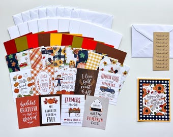 May include: A collection of fall-themed greeting cards and stationery. The cards feature autumn designs with pumpkins, sunflowers, and text like "Hello gourd-geous" and "Farmers Market." Includes envelopes and decorative tags.