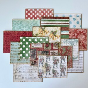 May include: A collection of 12 vintage Christmas themed paper cards with various designs, including polka dots, stripes, musical notes, and a Santa Claus pattern. The cards are in shades of red, green, blue, and white.