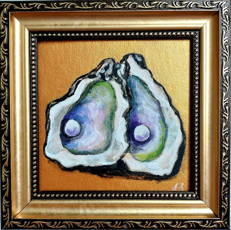 May include: A framed painting of two open oyster shells with iridescent purple, green, and white interiors, each containing a single white pearl. The artwork is set against a metallic gold background and enclosed in a decorative dark brown and gold frame.