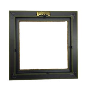 May include: A square picture frame with a dark olive green outer border and a black inner border. The frame features a metallic gold-toned sawtooth hanger centered on the top edge for wall mounting, with visible corner joinery details.