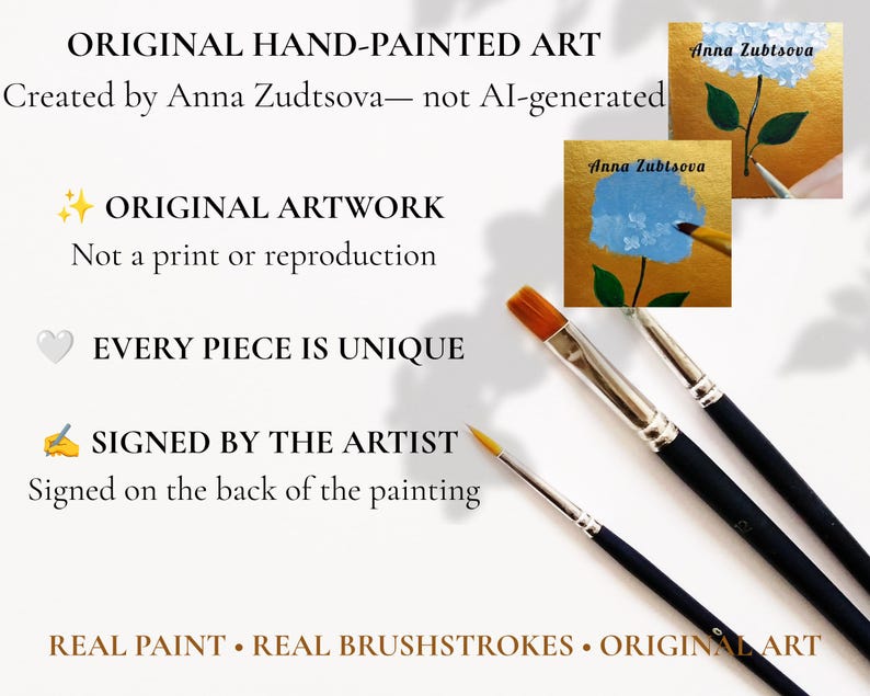 May include: Three black-handled paintbrushes with silver ferrules and synthetic bristles are positioned near two small square paintings of blue hydrangea flowers on gold backgrounds, featuring the artist's signature Anna Zubtsova.