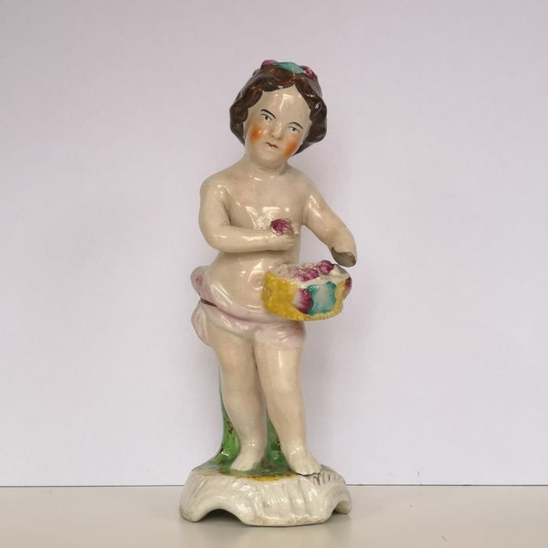 A Bow Porcelain Factory Model Of A Putto With Flower Basket, Circa 1750